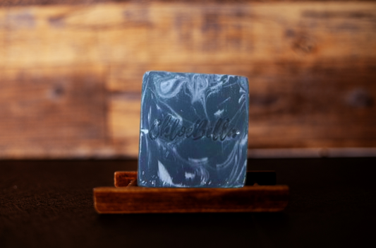 Handcrafted silver fox men's soap body bar sitting on a wooden stand
